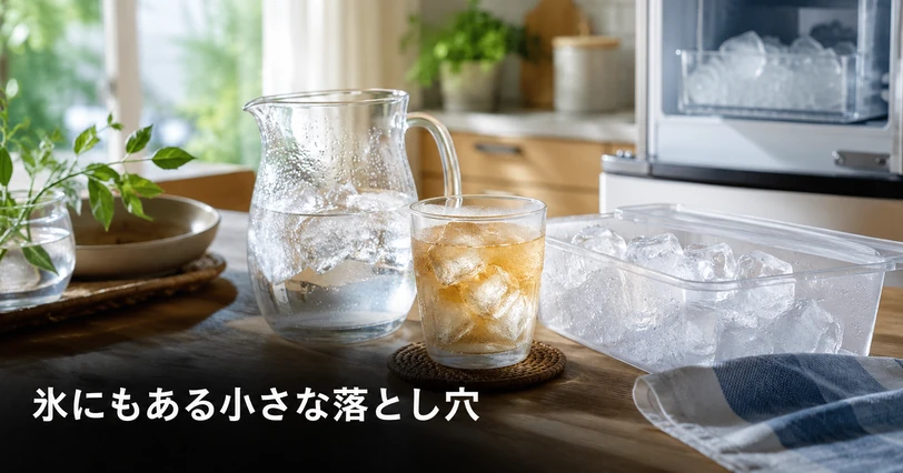 製氷機の氷と氷を入れた麦茶のグラスが並ぶキッチンで、家庭の氷づくりと手入れの注意点を思わせるイメージ